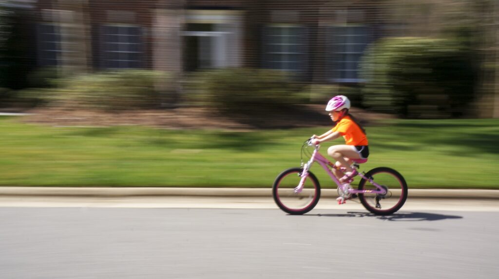 Girl riding her bike in a neighborhood